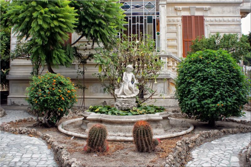 A formal statuary garden blends well with the architectural style of this house